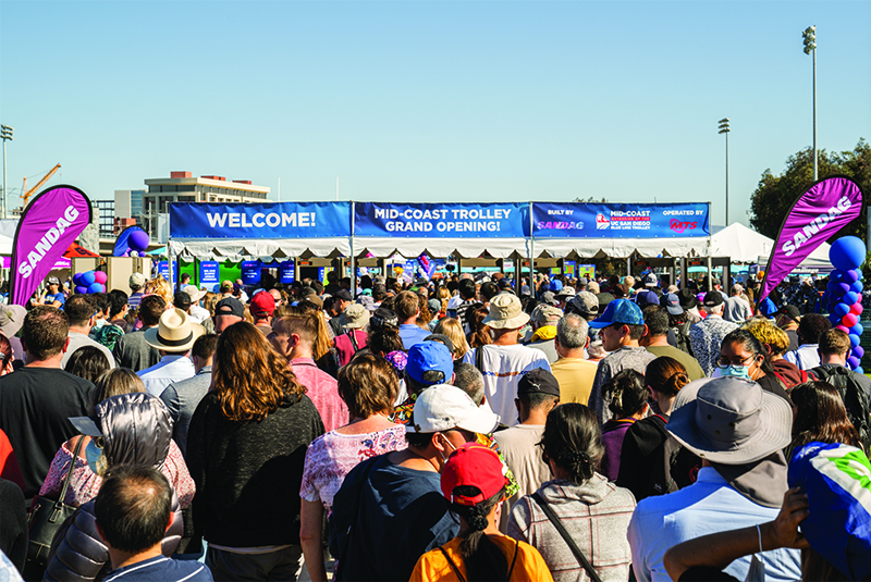 Crowds gather at the entrance to the Mid-Coast Trolley Grand Opening Celebration
