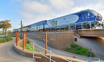An Amtrak Pacific Surfliner train traveling northbound passing through the El Portal Undercrossing in Encinitas, San Diego.